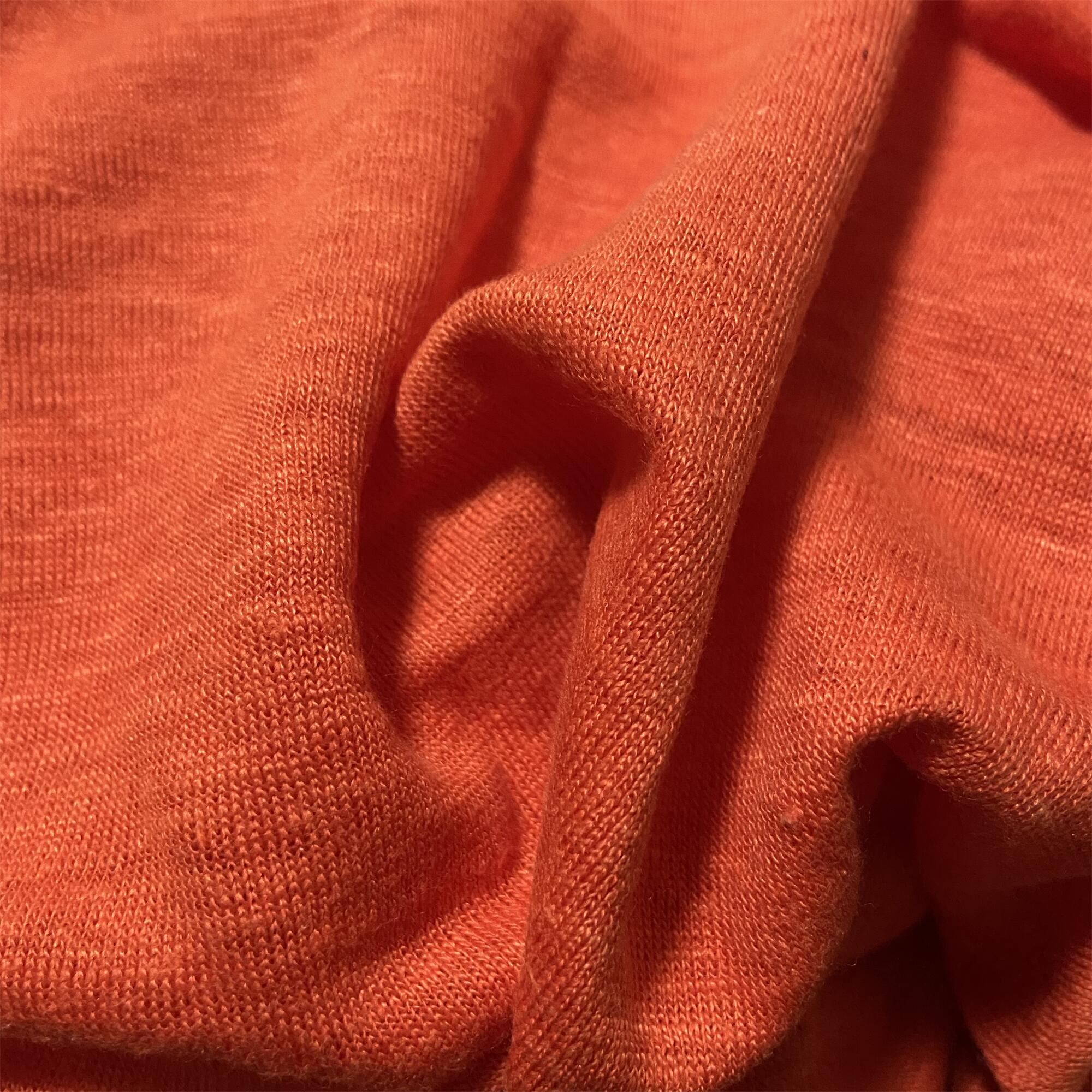Organic hemp knit fabric rolling out during textile manufacturing process